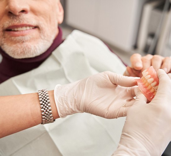 Man learning about the cost of dentures in Rockledge