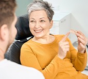  Woman asking dentist about dentures