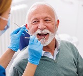 Mature man smiling during dental checkup