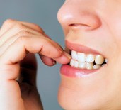 Closeup of person biting their nails