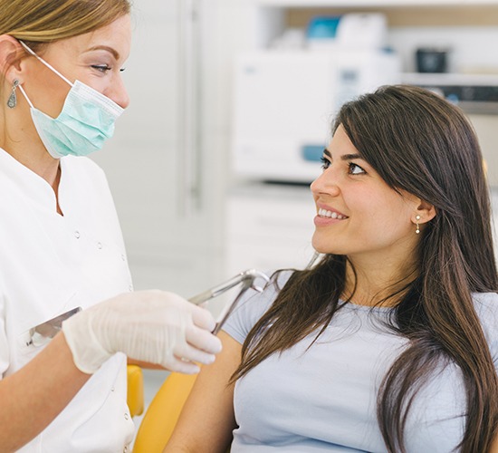 a patient chatting with her dentist about tooth extraction