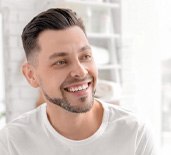 smiling man in white shirt