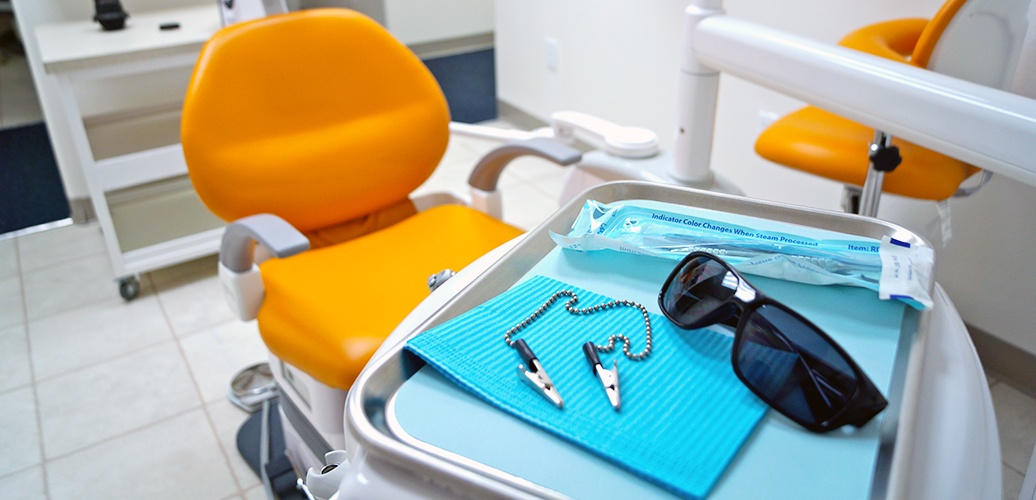 tray with sunglasses, toothbrush, and bib
